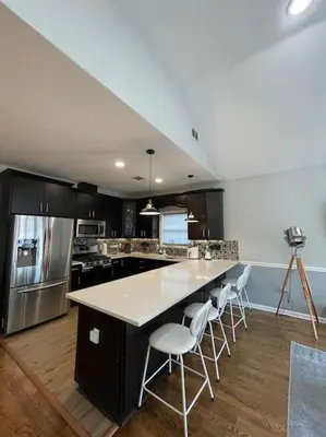 a kitchen with a large island with white counter tops at Modern minimalistic 3 bdr Apt Townhouse in Jersey City