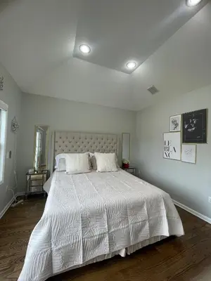 a white bedroom with a large bed with white sheets at Modern minimalistic 3 bdr Apt Townhouse in Jersey City