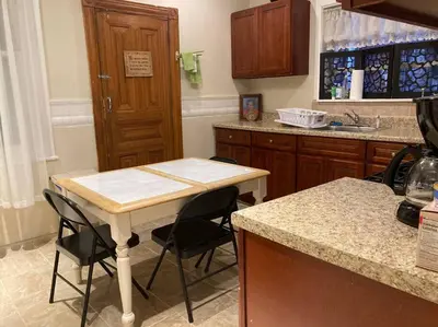 a kitchen with a table and some chairs in it at Black Oak Rest in Philadelphia