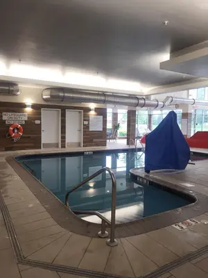 a swimming pool with a blue tent in the middle at Fairfield Inn & Suites by Marriott in Breinigsville