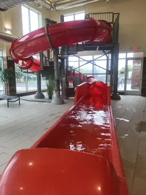a red slide in a building with a pool of water at Fairfield Inn & Suites by Marriott in Breinigsville