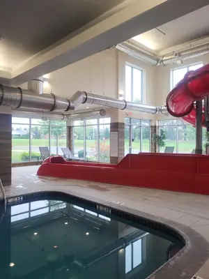 a swimming pool in a building with a slide at Fairfield Inn & Suites by Marriott in Breinigsville