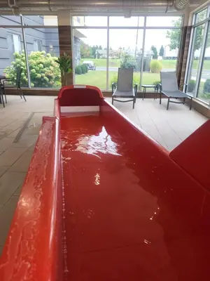 a pool of red water in a room with chairs at Fairfield Inn & Suites by Marriott in Breinigsville