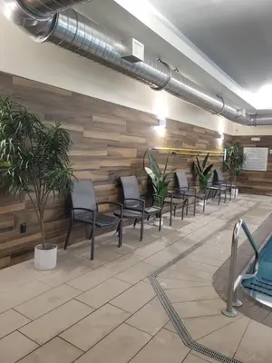 an empty waiting room with chairs and plants at Fairfield Inn & Suites by Marriott in Breinigsville