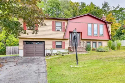 a red house with a garage and a driveway at Family Home Close to Warwick, 5 Mi to Lake! in Monroe