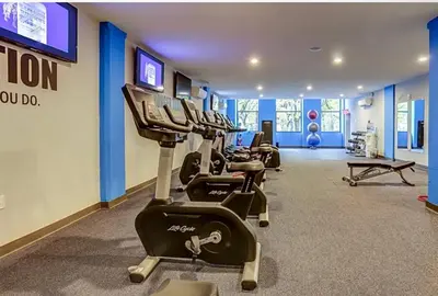 a gym with rows of exercise bikes in a room at Modern 1BR with Rooftop Pool & Gym in Philadelphia