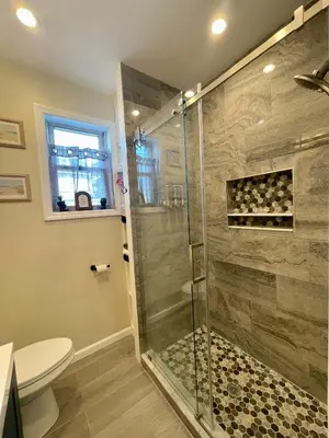 a bathroom with a glass shower with a toilet at New York City Private Bedroom Near Free Ferry Boat! in Stapleton