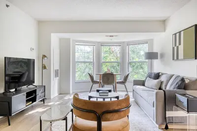a living room with a couch and a table at Jersey City 2br w wd gym elevator nr path NYC-672 in New York