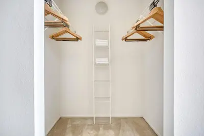 a room with white walls and wooden shelving at Jersey City 2br w wd gym elevator nr path NYC-672 in New York
