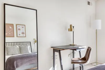 a mirror in a bedroom with a desk and a bed at Jersey City 2br w wd gym elevator nr path NYC-672 in New York