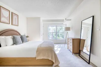 a bedroom with a large bed and a mirror at Jersey City 2br w wd gym elevator nr path NYC-672 in New York