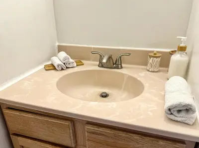 a bathroom sink with a white counter top at Modern Lakefront Oasis Relaxing Hot Tub Sauna Game Rooms Stunning Views! in East Stroudsburg