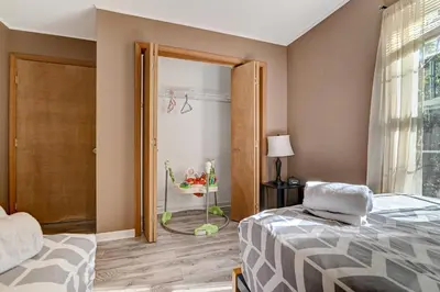 a bedroom with a bed and a window and a door at Modern Lakefront Oasis Relaxing Hot Tub Sauna Game Rooms Stunning Views! in East Stroudsburg