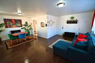 a living room with a blue couch and a table at Bright & cozy 2nd Floor Apartment Close to NYC in Bloomfield