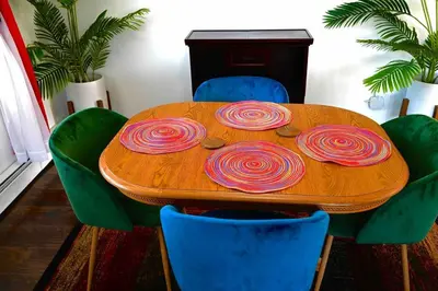 a wooden table with four fake roses on it at Bright & cozy 2nd Floor Apartment Close to NYC in Bloomfield