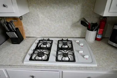 a white stove top oven in a kitchen at Bright & cozy 2nd Floor Apartment Close to NYC in Bloomfield