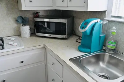 a kitchen counter with a sink and a microwave at Bright & cozy 2nd Floor Apartment Close to NYC in Bloomfield