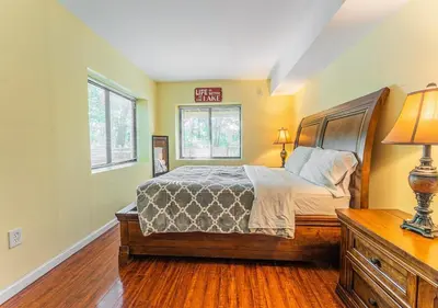 a bedroom with a bed and a sign on the wall at Charming Lakefront Getaway with Hot Tub & Game Room Perfect for Families! in East Stroudsburg
