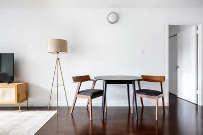 a dining room table with four chairs and a lamp at Blueground Chelsea gym doorman nr market NYC-494 in New York