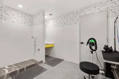 a bathroom with a shower and a chair in it at Blueground Chelsea gym doorman nr market NYC-494 in New York