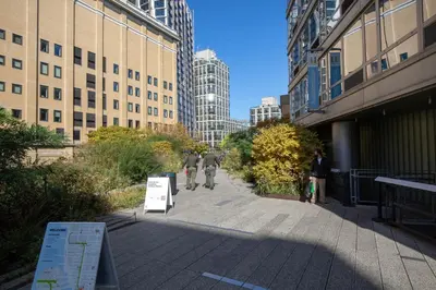 two people walking down a sidewalk in a city at Blueground Chelsea gym doorman nr market NYC-494 in New York