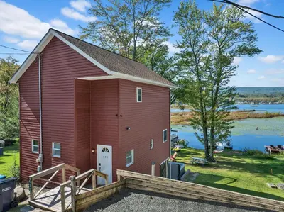 an image of a red barn with a lake in the background at Lakefront, Hot Tub, Dock, Kayaks, Amazing Views in Lake Ariel