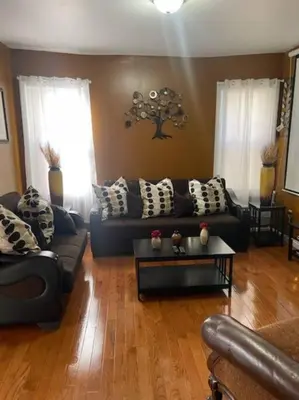 a living room with a couch and a table at Large 3 BRM 2 Bath Near EWR NYC in Newark