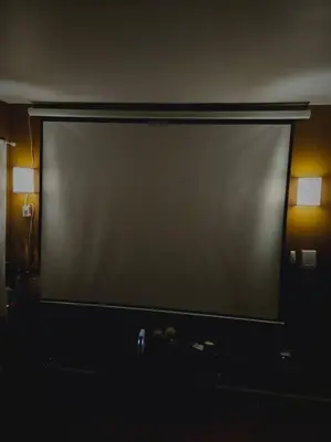 a large screen in a dark room with two lights at Large 3 BRM 2 Bath Near EWR NYC in Newark