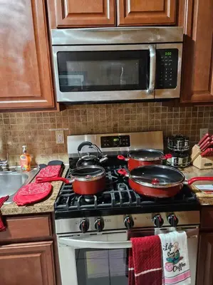 a kitchen with a stove with pots and pans on it at Large 3 BRM 2 Bath Near EWR NYC in Newark