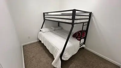 a bedroom with a bunk bed with white sheets at Peaceful home in mount bethel, PA in Mount Bethel