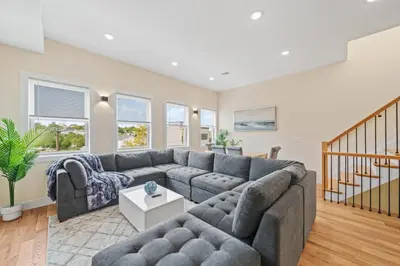 a living room with a couch and a table at Skyline Serenity Luxe NYC Retreat in Jersey City