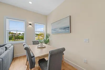 a living room with a table and a couch at Skyline Serenity Luxe NYC Retreat in Jersey City