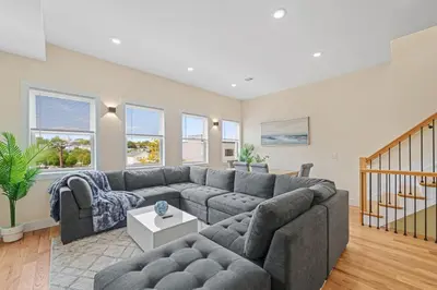 a living room with a couch and a table at Skyline Serenity Luxe NYC Retreat in Jersey City