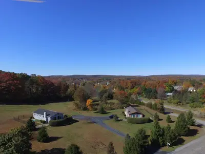 an aerial view of a home in the woods at Fenced Yard Chalets from Good Dog Vacations at Big Valley Resort in Sciota