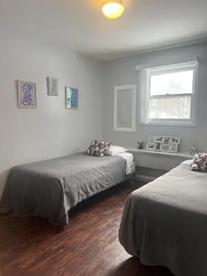 a bedroom with two beds and a window at Fenced Yard Chalets from Good Dog Vacations at Big Valley Resort in Sciota