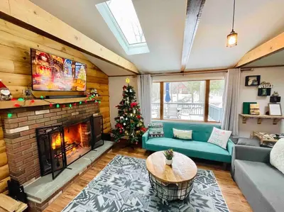 a living room with a christmas tree and a fireplace at Pocono Lake House Beach, AC in Locust Lakes Village