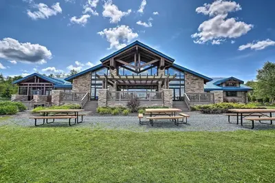 a group of picnic tables in front of a building at Pocono Lake House Beach, AC in Locust Lakes Village