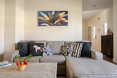 a living room with a couch and a table at Perfect Family Getaway! Steps from Attractions in Hummelstown