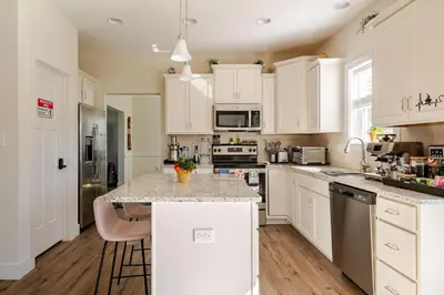 a kitchen with white cabinets and a marble counter top at Perfect Family Getaway! Steps from Attractions in Hummelstown