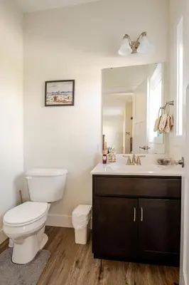 a bathroom with a toilet and a sink with a mirror at Perfect Family Getaway! Steps from Attractions in Hummelstown