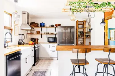 a kitchen with white cabinets and black appliances at Eldred Manor in Eldred