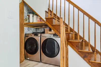 a washing machine in a room with a staircase at Eldred Manor in Eldred