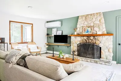 a living room with a couch and a fireplace at Eldred Manor in Eldred