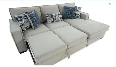 a white couch with blue pillows on it at Hoboken Hideaway - Walk to Transit - 15 Mins to NYC in Hoboken