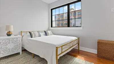 a white bedroom with a bed and a window at Modern Chic Fishtown-Philly Home with Roof Deck in Philadelphia