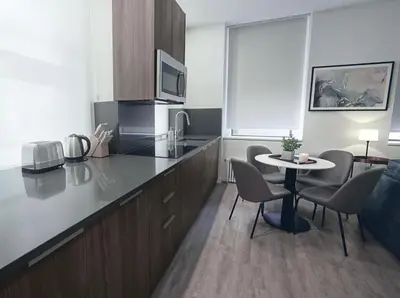 a kitchen with a table and chairs and a room at One Dutch Hotel in New York