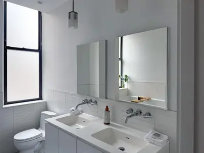 a white bathroom with a sink and a toilet at One Dutch Hotel in New York
