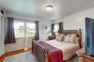 a bedroom with a bed and a tv and a window at Work and Play! Home 1 Mi to Dtwn and Central Market in York