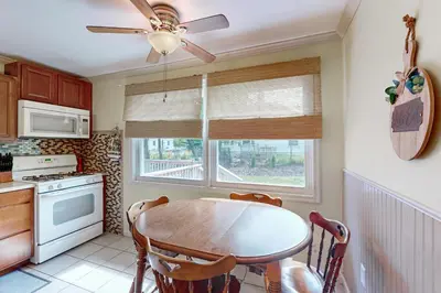 a kitchen with a table and a ceiling fan at Work and Play! Home 1 Mi to Dtwn and Central Market in York