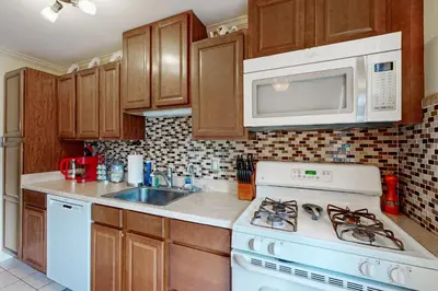 a kitchen with a white stove and a microwave at Work and Play! Home 1 Mi to Dtwn and Central Market in York